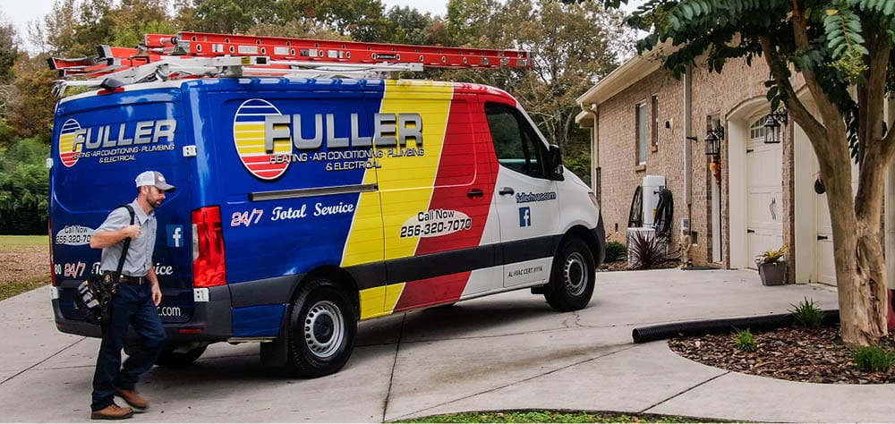 Fuller HVAC service van parked in a residential driveway as a technician approaches the home.