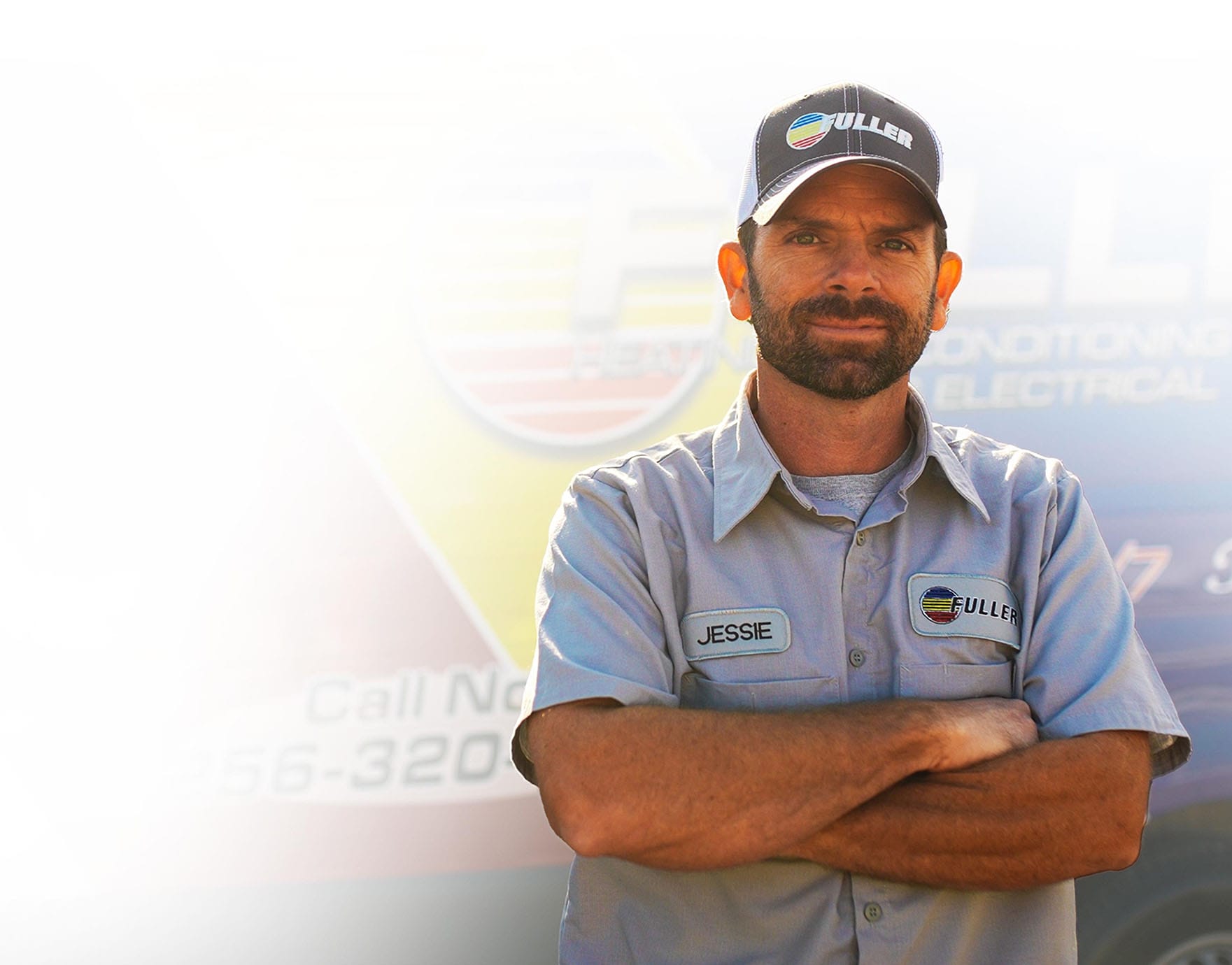 Fuller technician standing confidently with arms crossed in front of a brightly branded service van.