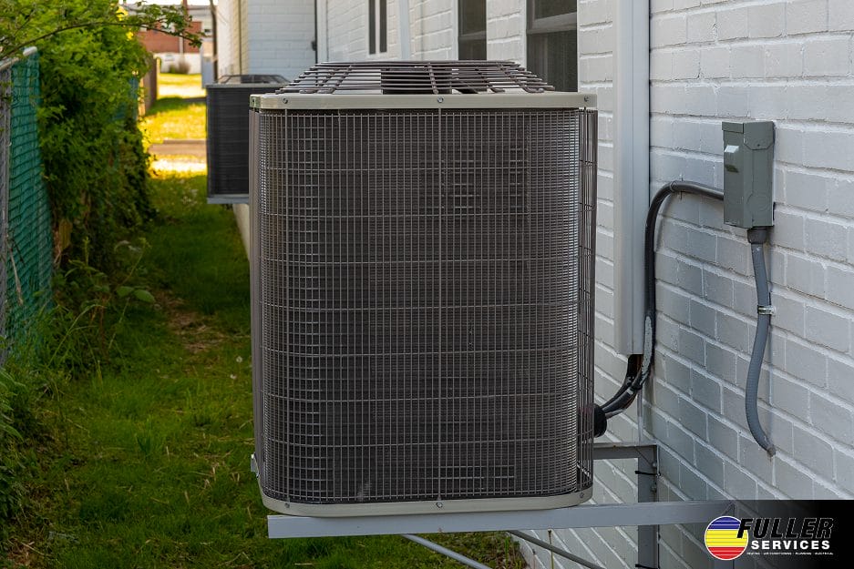 Outdoor HVAC unit next to a house, providing efficient air conditioning and heating for residential climate control.