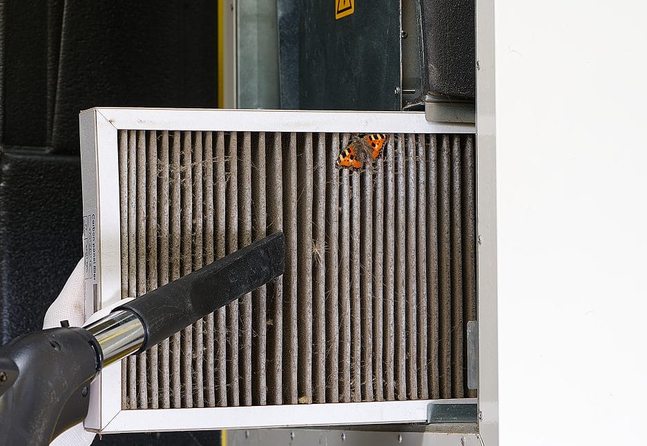 Cleaning a dirty HVAC air filter to remove dust and allergens, enhancing indoor air quality and system performance.
