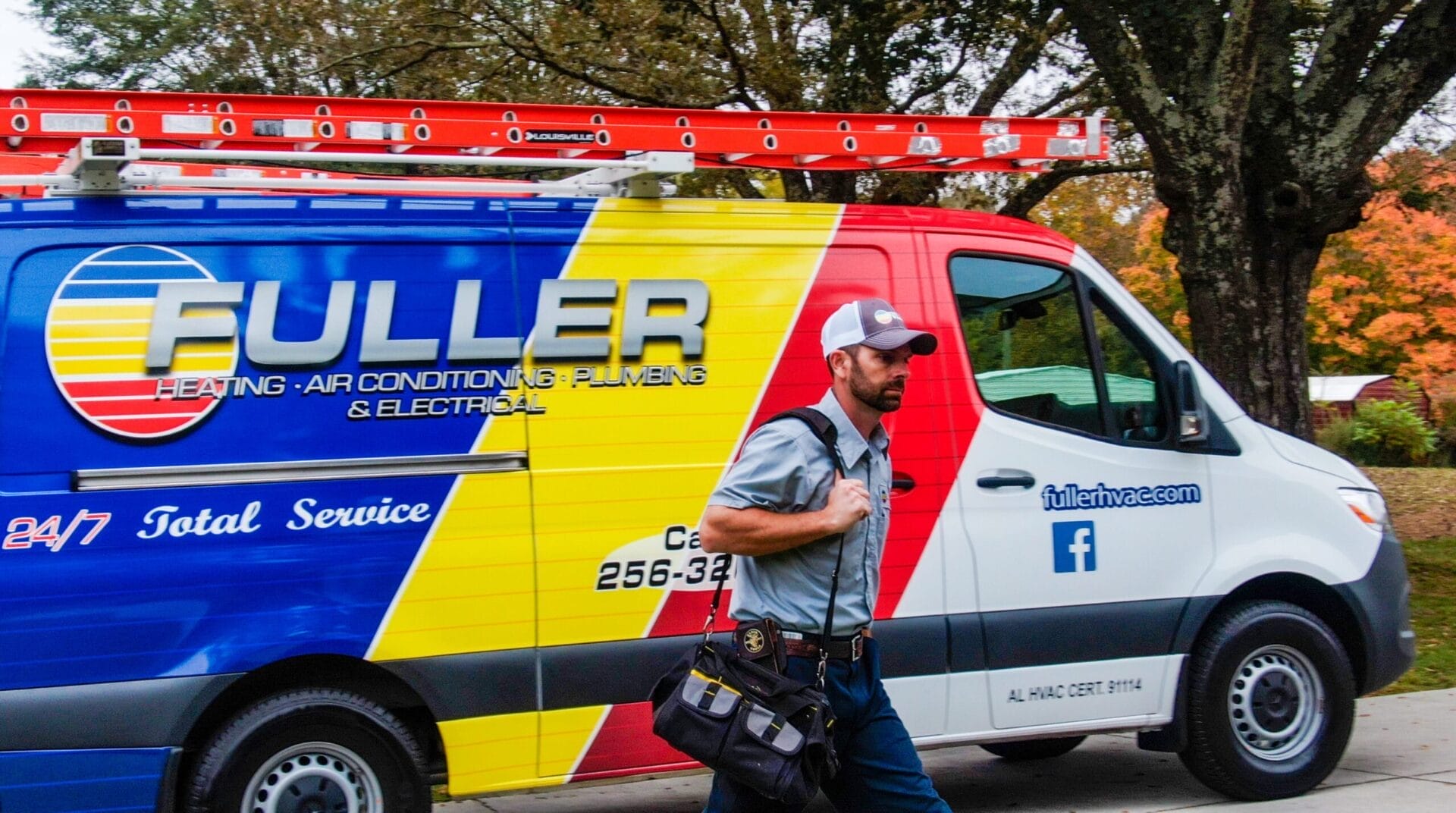 Fuller HVAC technician standing ready beside company service van